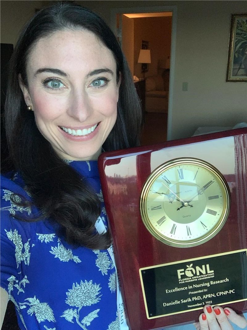 Dr. Danielle Sarik holding FONL award