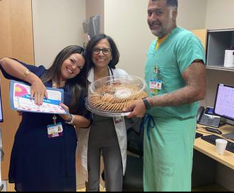 awardee wearing a headband of daisies, daisy award statue, and certificate.